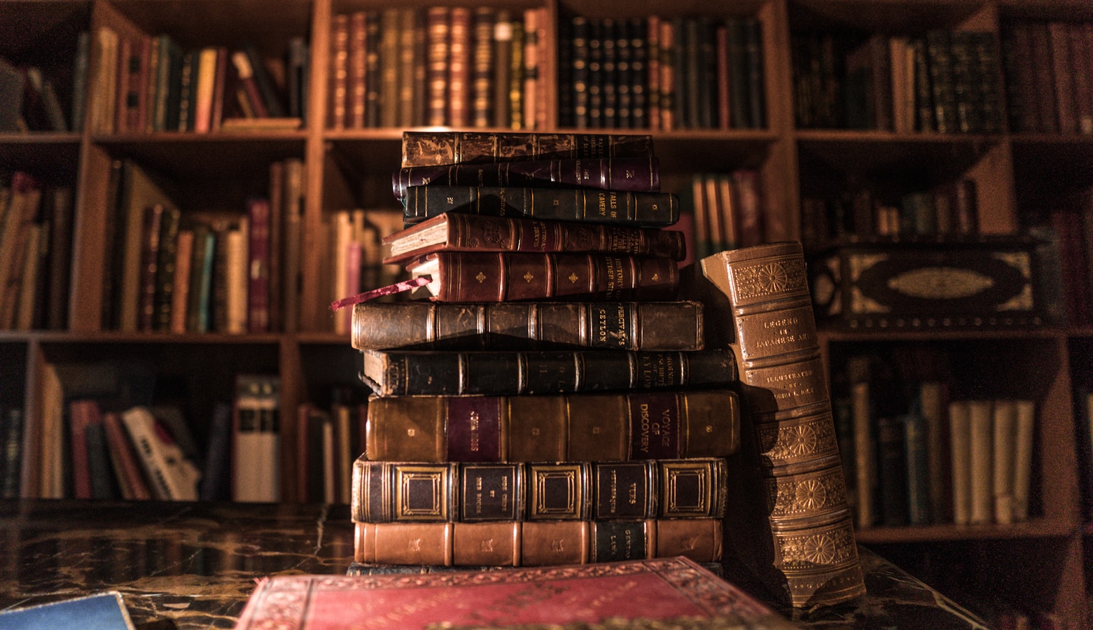 piled books on brown wooden shelf from The Psychology Behind Reading Order Preferences