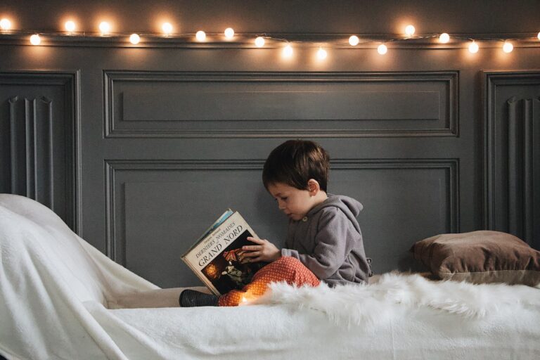 boy reading book on bed from 5 Best Series for 10-Year-Olds